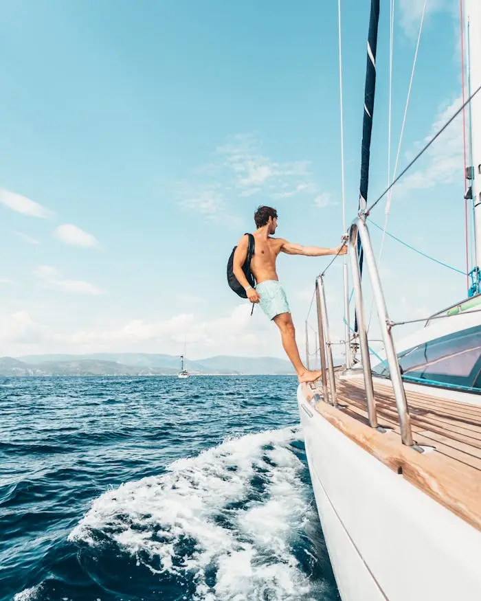 A man enjoys sailing on the Aegean Sea, showcasing freedom and leisure on a sunny day.